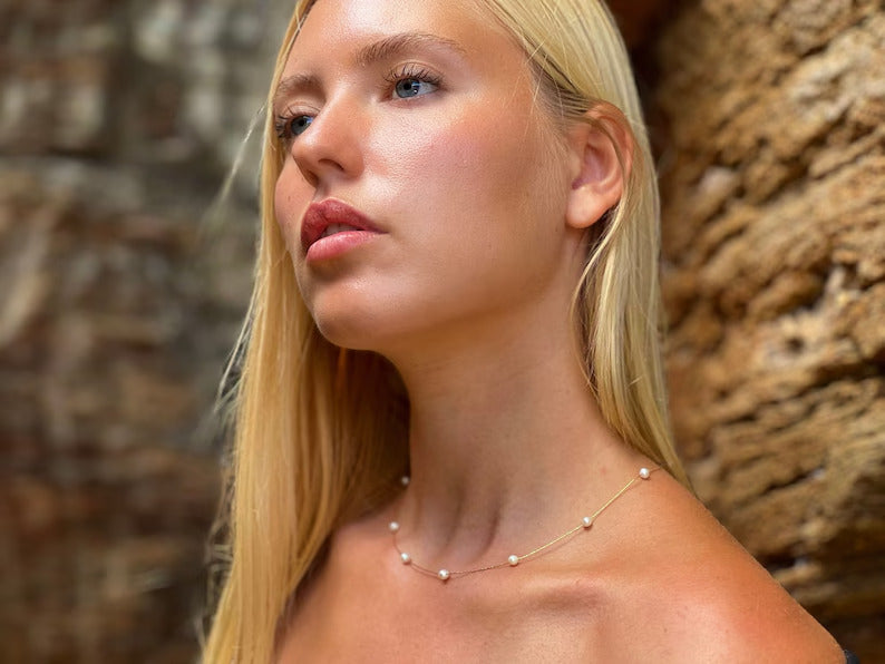 Elegant 14k gold pearl necklace featuring lustrous pearls, perfect for special occasions.Charming tiny pearl necklace showcasing petite pearls, a subtle accessory for any outfit.